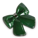 A glossy dark green enamel bow pin with a silver-tone metal clasp, shown on a plain white background.