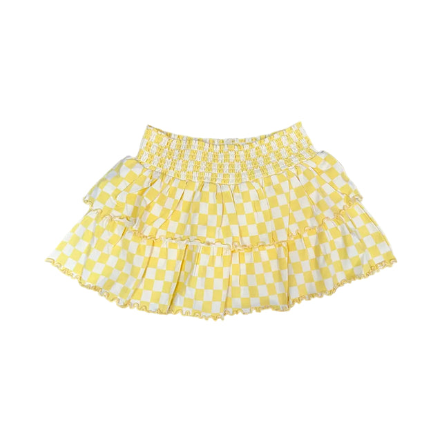Yellow checkered skirt on a light yellow background