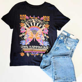 Black t-shirt with colorful graphic design and denim shorts on a light background