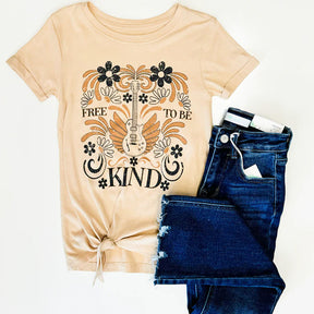 Beige t-shirt with 'Free to be Kind' design and blue jeans on a white background