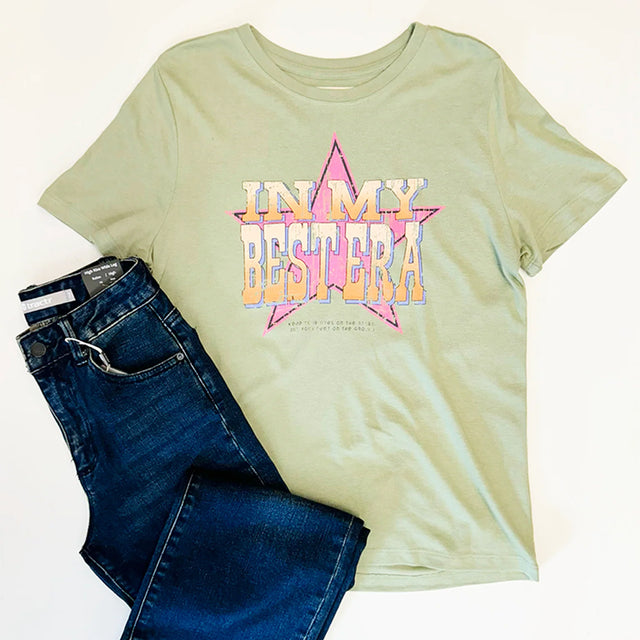 Light green t-shirt with 'IN MY BESTERA' text and blue jeans on a white background