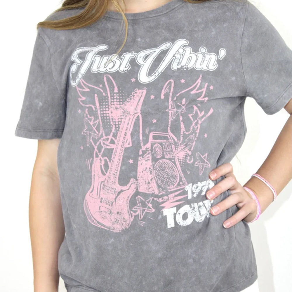 Gray t-shirt with pink graphic design and text worn by a person
