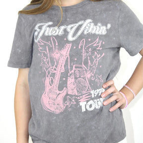 Gray t-shirt with pink graphic design and text worn by a person