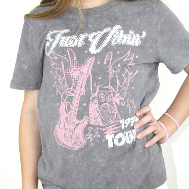 Gray t-shirt with pink graphic design and text worn by a person
