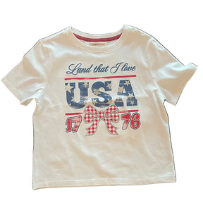 White t-shirt with 'Land that I love USA 1776' text on a white surface