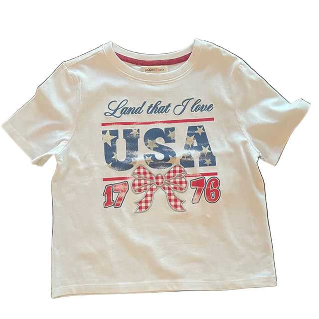 White t-shirt with 'Land that I love USA 1776' text on a white surface