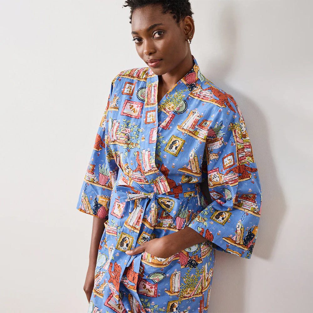 Woman wearing a blue patterned robe against a plain background