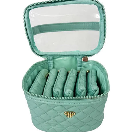 Mint green jewelry case with quilted design and clear top compartment on a white background