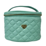 Quilted turquoise cosmetic bag with gold zipper and logo on a white background