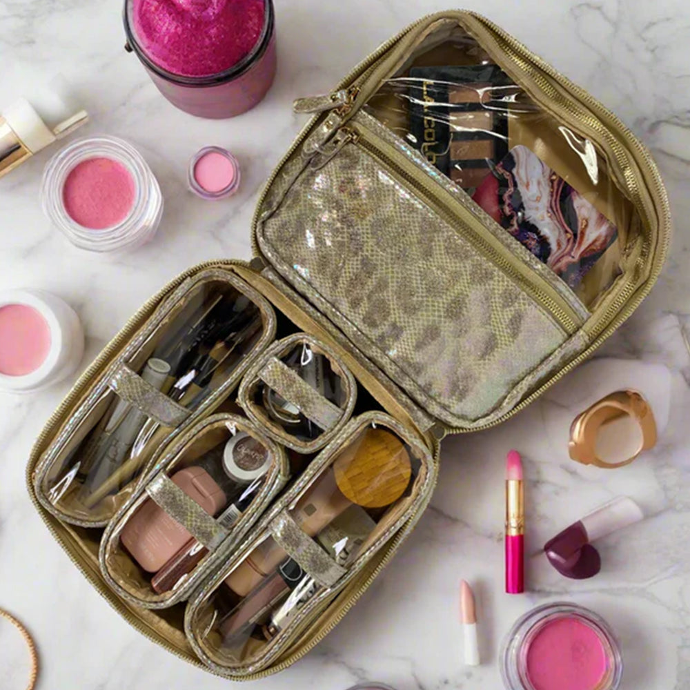 Makeup case with various cosmetic items on a marble surface