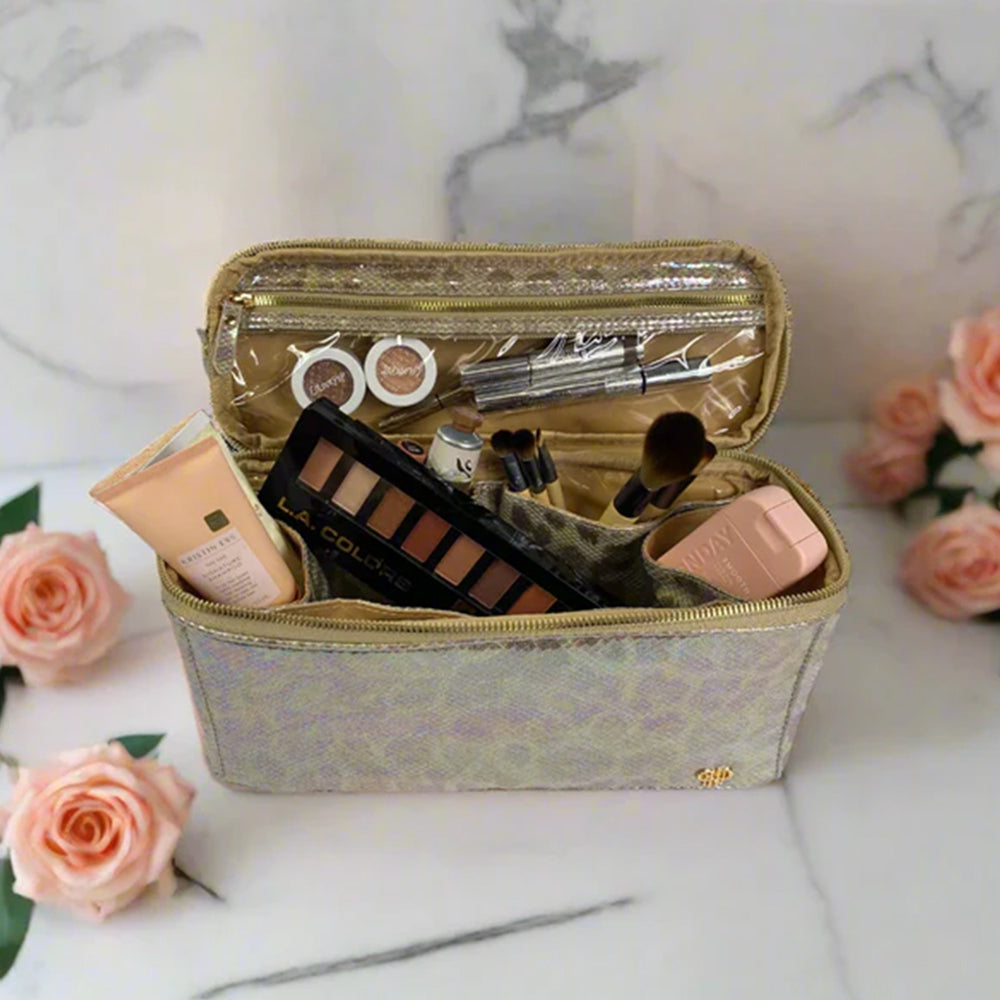Makeup bag with cosmetic items on a marble surface with roses