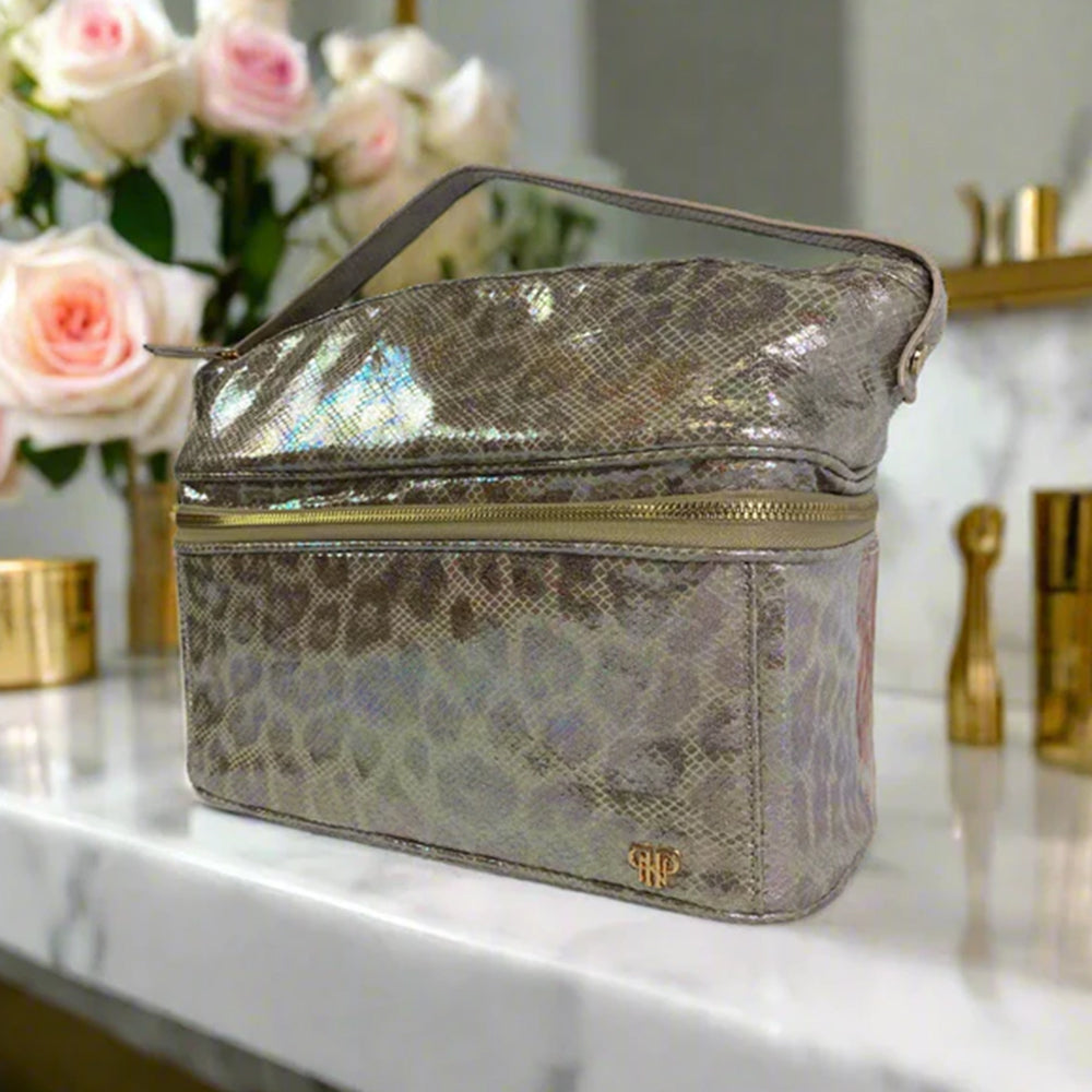 Makeup bag with leopard print pattern on a marble surface with flowers and beauty products in the background