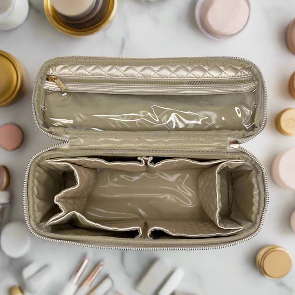 Open beige makeup case with cosmetic items on a marble surface