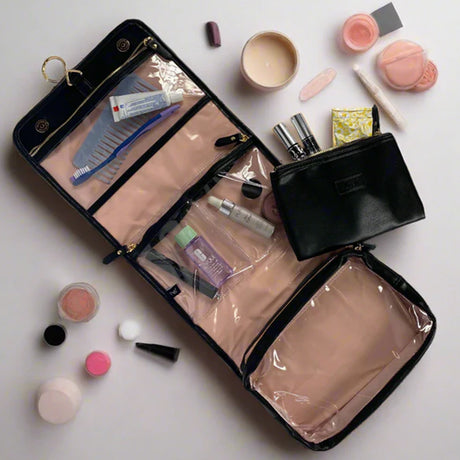 Makeup bag with various cosmetic items on a light background