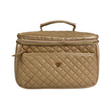 Beige quilted cosmetic bag with gold zipper and handle on a white background