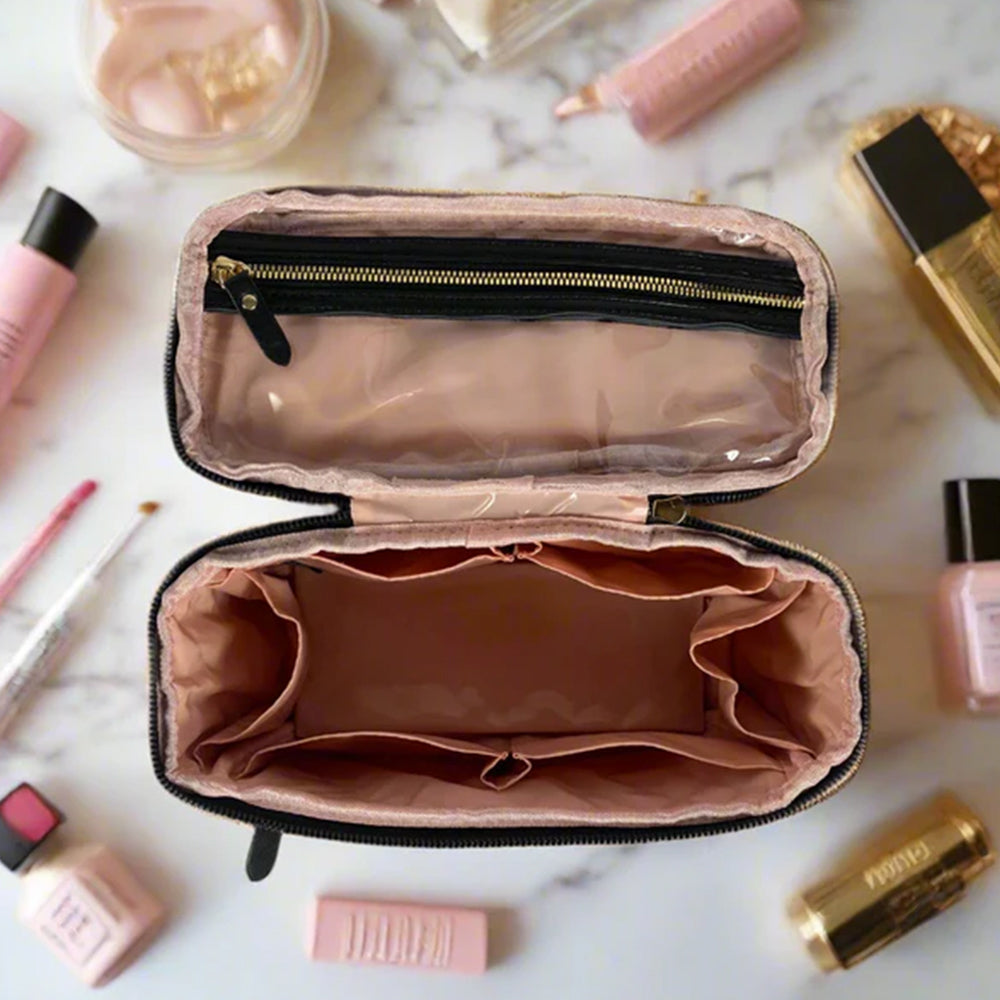 Open makeup case with cosmetic products around on a marble surface