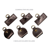 Set of brown earring stays and necklace holders on a white background