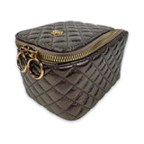 Quilted gray pouch with gold zipper and circular handles on a white background