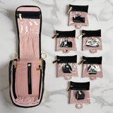 Pink travel jewelry organizer with multiple small bags on a white background