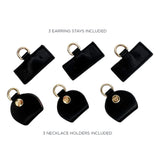 Black earring stays and necklace holders on a white background