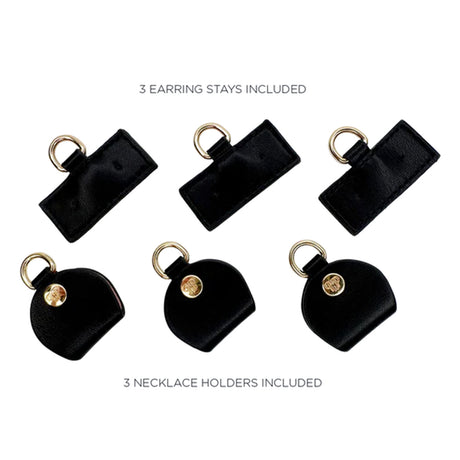 Black earring stays and necklace holders on a white background