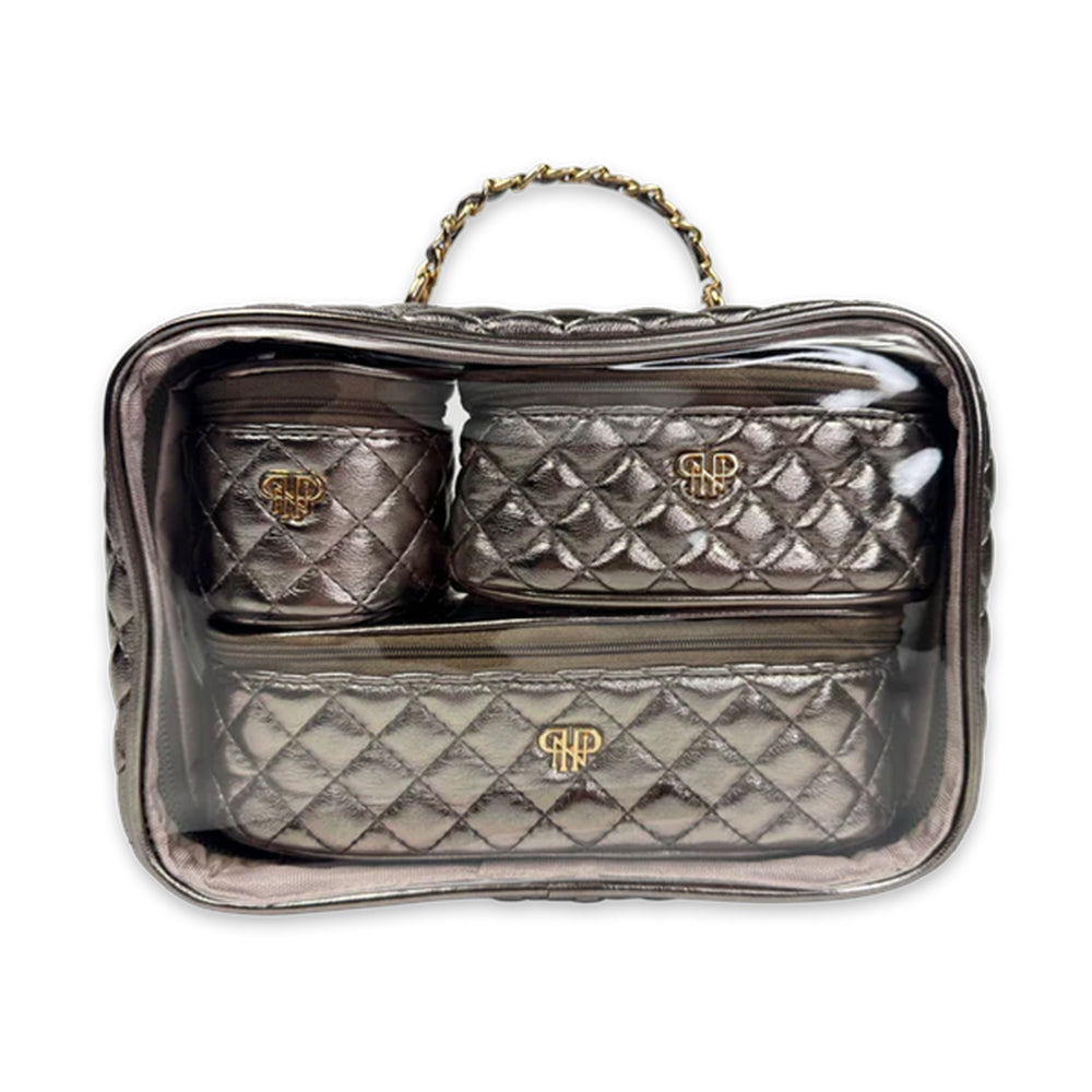 Quilted handbag with gold logo on a clear stand against a white background