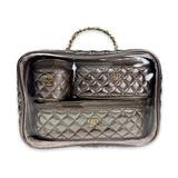 Quilted handbag with gold logo on a clear stand against a white background