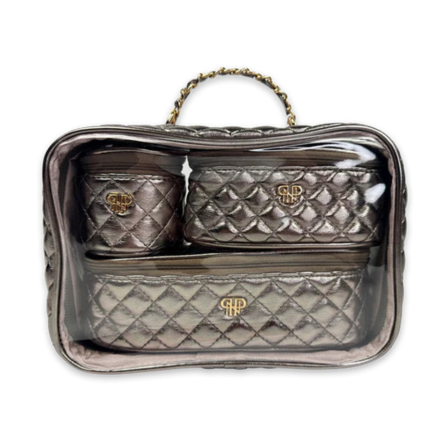Quilted handbag with gold logo on a clear stand against a white background