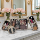 Makeup bags with cosmetic items on a marble countertop with roses in the background
