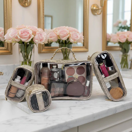 Makeup bags with cosmetic items on a marble countertop with roses in the background