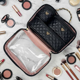 Makeup bag with quilted design and visible brand logo, surrounded by makeup items on a light background