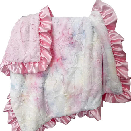 Floral-patterned quilt with pink ruffles on a wooden frame against a white wall.