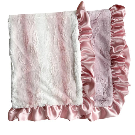 Pink textured blanket with ruffled edges on a white background