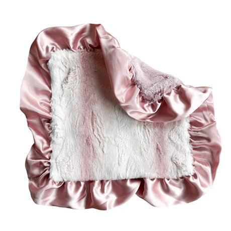 White fluffy pillow with pink satin trim on a white background