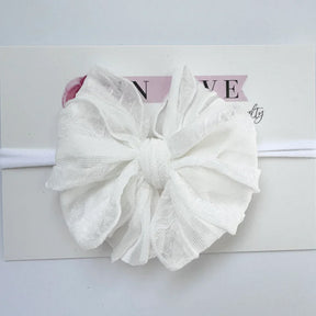 White lace bow headband on a white background