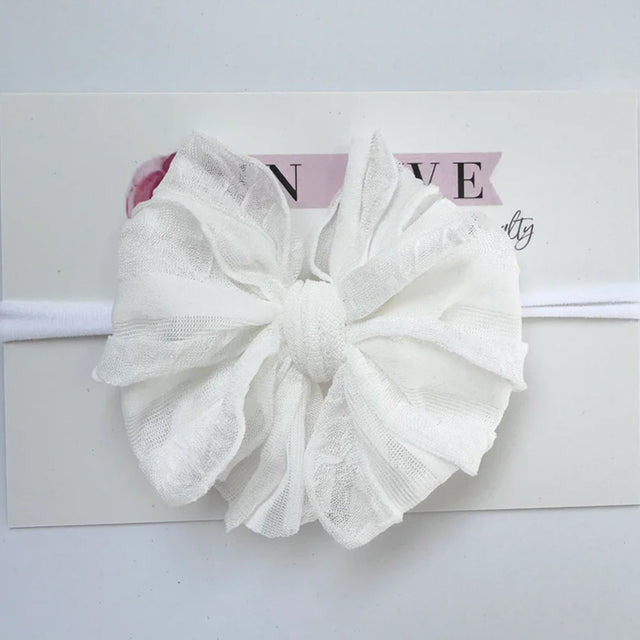 White lace bow headband on a white background