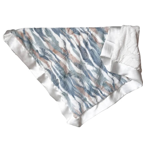 Textured fabric with blue and brown pattern draped over a rack against a white wall