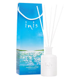 Inis fragrance diffuser in packaging, displaying a white bottle with a blue label and cap, and a box with a clear blue sky and greenery illustration.