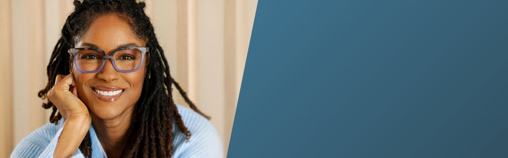 African American Woman smiling and wearing Peepers reading glasses