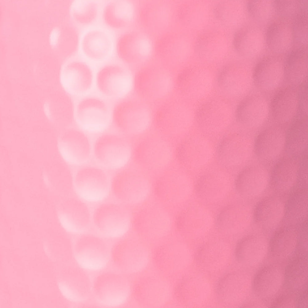 A close-up of a pink textured surface with a raised vertical row of circular dimples or bubbles on the left side.