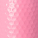 A close-up of a pink textured surface with a raised vertical row of circular dimples or bubbles on the left side.