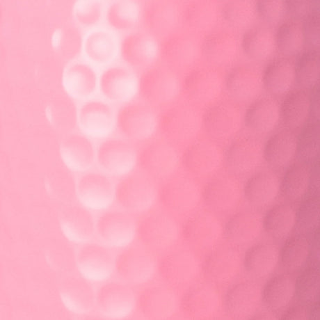A close-up of a pink textured surface with a raised vertical row of circular dimples or bubbles on the left side.
