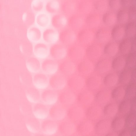 A close-up of a pink textured surface with a raised vertical row of circular dimples on the left and a smoother dotted pattern on the right.