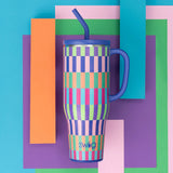 Colorful striped tumbler with a blue lid and straw on a geometric patterned background