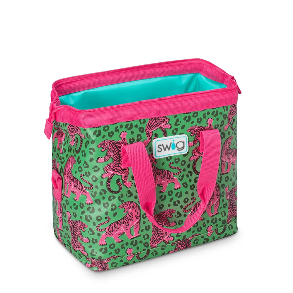 A Swig branded cooler bag featuring a green and pink leopard print pattern with pink tiger illustrations, bright pink handles and zipper trim, and a turquoise interior lining.