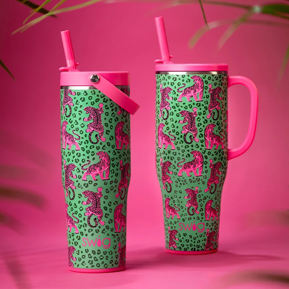 Two pink and green insulated tumblers with seahorse prints, shown on a bright pink background with decorative palm leaves.