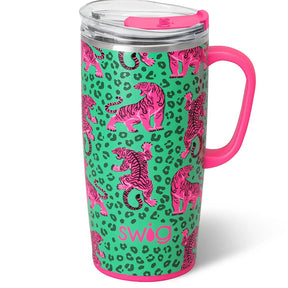 A stainless steel travel tumbler with a bright pink handle and lid, featuring a green and pink leopard print background with pink tiger illustrations and the brand name 'swig' printed near the bottom.