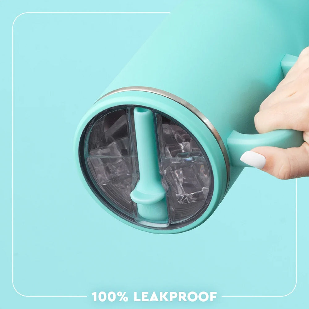 A close-up of a hand holding a mint green insulated tumbler with a clear lid and leakproof silicone seal, set against a matching mint green background with the text '100% LEAKPROOF' at the bottom.