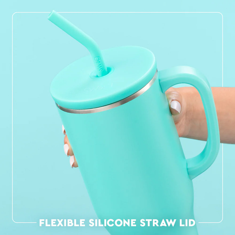 Turquoise tumbler with handle and flexible silicone straw lid on a light blue background