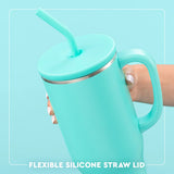 Turquoise tumbler with handle and flexible silicone straw lid on a light blue background